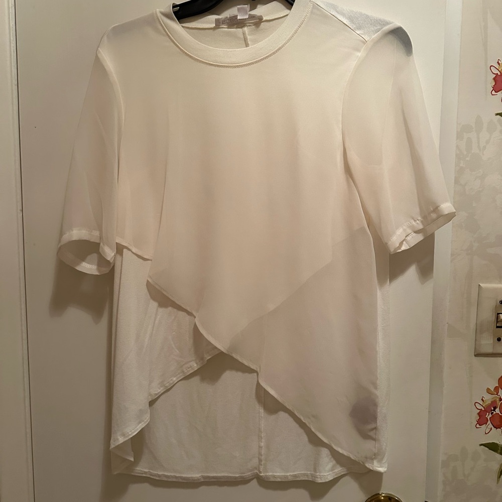 White short sleeve blouse with see through sleeves.